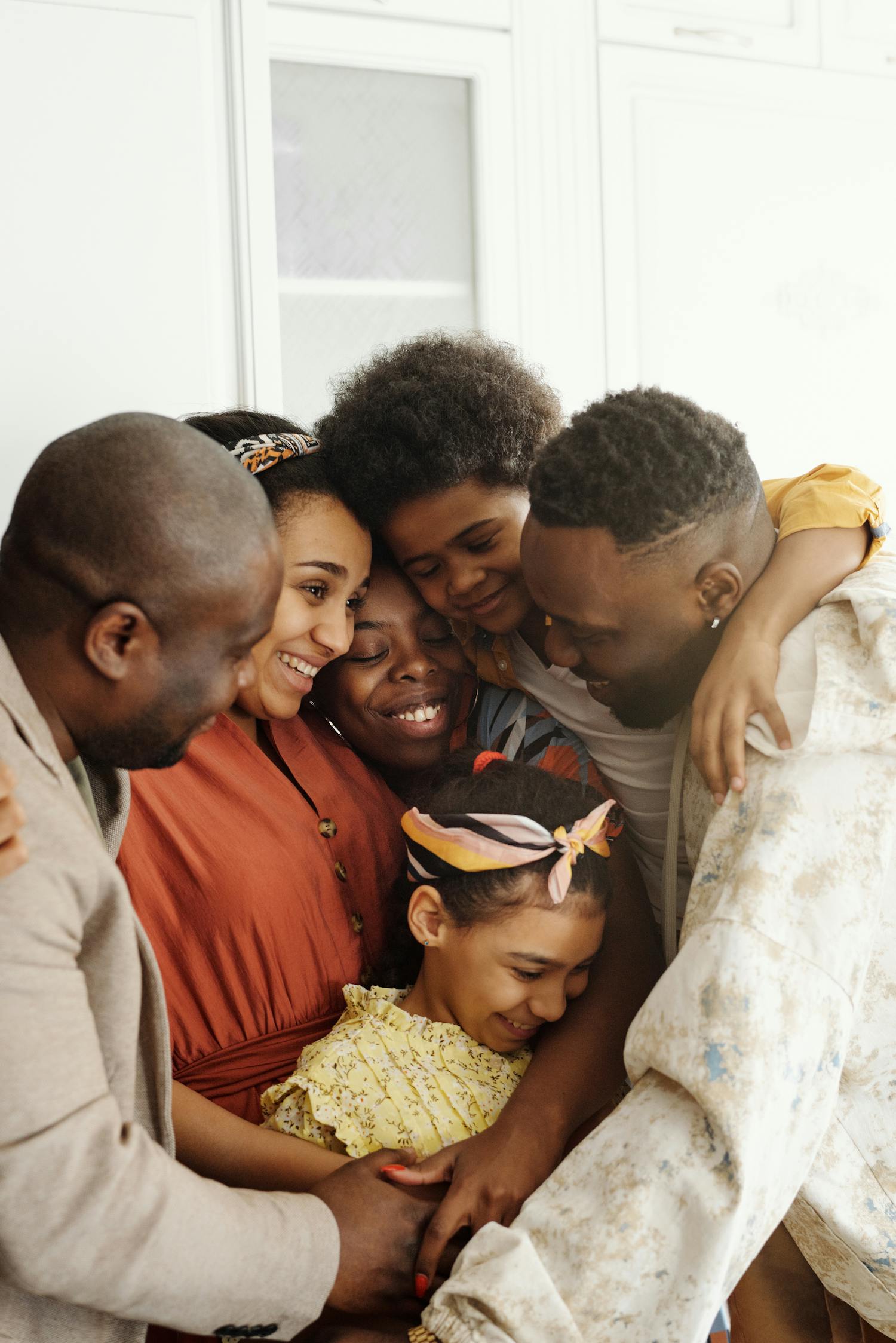 A family holding each other close, smiling together